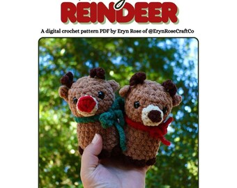 May include: Two crocheted reindeer toys with brown bodies, red noses, and small antlers. One wears a green scarf, the other a red scarf. The image includes the text "Remy the REINDEER" and information about a digital crochet pattern.