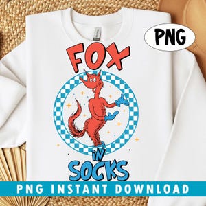 May include: White sweatshirt with a cartoon fox in socks design. The fox is red with blue gloves, set within a blue and white checkered circle. The words "FOX" and "SOCKS" are in red and blue. The text "PNG INSTANT DOWNLOAD" is at the bottom.