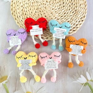 May include: Set of six crocheted heart-shaped plushies with embroidered eyes and legs. Each heart holds a small card with a different message, such as "You make my heart skip a beat!" and "Keep this heart with you, always as a reminder that I will always love you!"