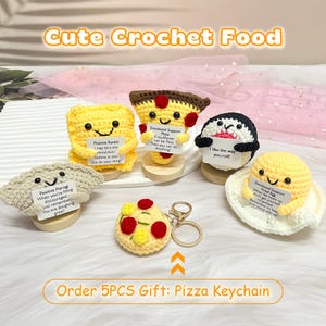 May include: Five crocheted food items with encouraging messages. The items include a pizza, a ravioli, a pierogi, a fried egg, and a penguin. The pizza is also a keychain.