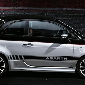 May include: Black and white racing stripes with the word "ABARTH" in white lettering. The stripes are designed to be applied to a car.