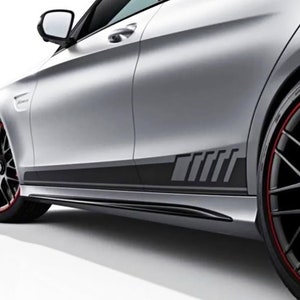 May include: A silver car with black side stripes that say "AMG" in a stylized font. The car has red accents on the wheels.
