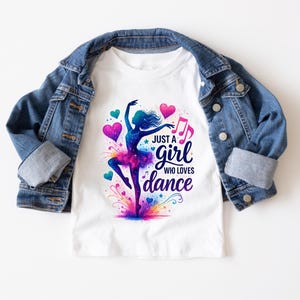 May include: White t-shirt with a colorful graphic of a dancer and the text "Just a girl who loves dance".