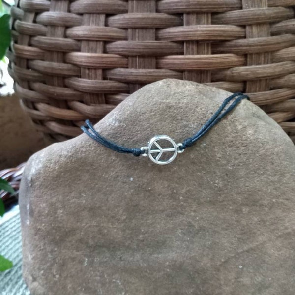 Peace sign charm on black cotton cord, adjustable to fit any wrist