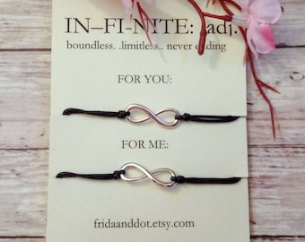 May include: Two black string bracelets with silver infinity symbol charms. The card reads "IN-FI-NITE: adj. boundless..limitless.. never ending" and "FOR YOU" and "FOR ME". The card also includes the website fridaanddot.etsy.com.