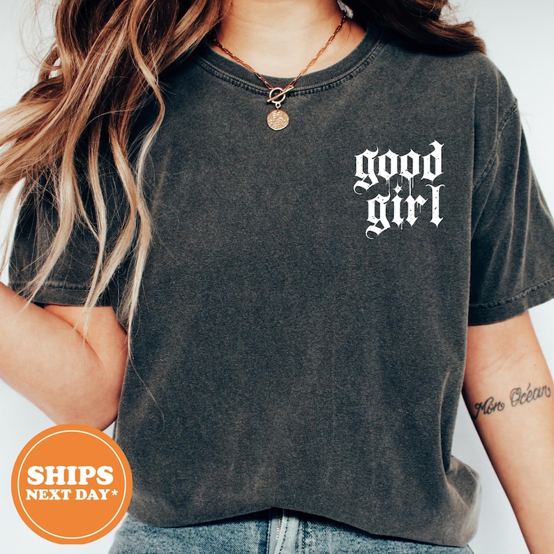 a woman wearing a shirt that says good girl