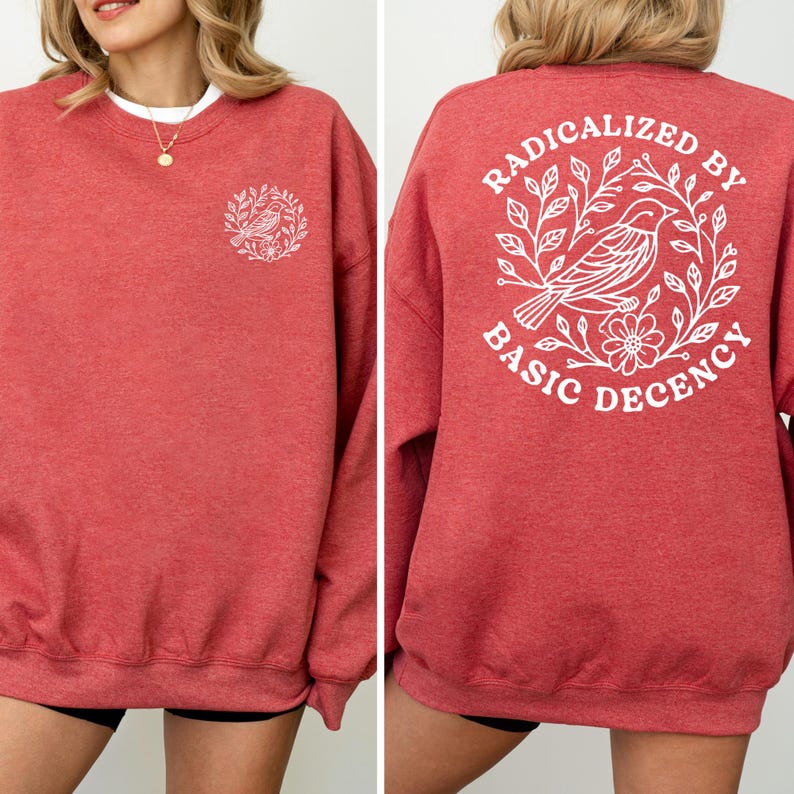 A red sweatshirt with a white design on the back, featuring a bird and floral elements.