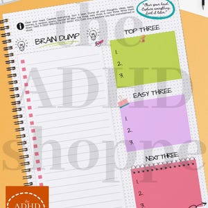 May include: A spiral-bound notebook featuring sections for a "Brain Dump," "Top Three," "Easy Three," and "Next Three." The notebook has a dotted grid and the text "Clear your head. Capture everything. Sort it later."