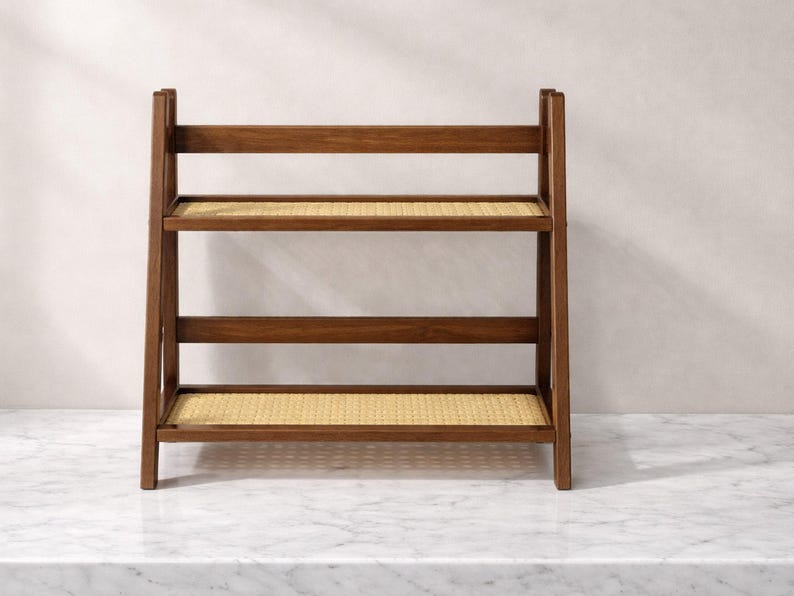 May include: A three-tiered wooden shelf with woven rattan shelves. The frame is a dark brown color, and the shelves are a light tan. The shelf is designed to stand on the floor and is suitable for storage or display.