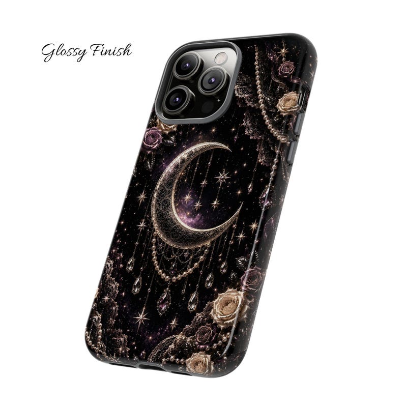 May include: Black phone case with a celestial design featuring a crescent moon, stars, and floral accents. The case has a glossy finish and the words "Glossy Finish" are printed on the upper left corner.