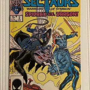 May include: A Marvel Sectaurs Warriors of Symbion comic book, issue number 2, titled Spidrax vs. Dargon. The cover features a colorful illustration of two armored figures riding large insect-like creatures in battle against a yellow background.