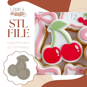 Puede incluir: Galletas con forma de cereza con cerezas rojas, hojas verdes y glaseado blanco. Las galletas están decoradas con lazos rosas y el número 12. También se ve el texto "STL FILE" y "Digital Product for 3D Printing".