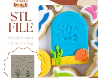 May include: A blue and yellow cookie cutter with a wave design and the text "Alfie Turns 2". The cookie cutter is designed for 3D printing.