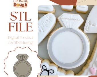 May include: A white cookie cutter in the shape of a ring with a diamond on top. The cookie cutter is on a white background. The text "STL FILE" is in the top left corner of the image. The text "Digital Product for 3D Printing" is below the text "STL FILE".