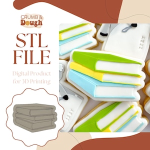 以下が含まれることがあります： 3Dプリント用の3冊の本のスタックをデジタルダウンロードできるSTLファイルです。画像は、本のように飾られた3つのクッキーのスタックを示しています。クッキーは、青、黄、緑のアイシングで飾られています。画像には、「STL FILE」と「3Dプリント用デジタル製品」というテキストが表示されています。
