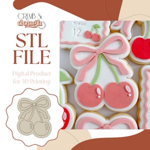 May include: An STL file for 3D printing, featuring a cherry and bow cookie cutter design. The image includes decorated biscuits with pink bows and cherries, and the text "CRUMB & dough SUGAR COOKIES".