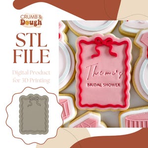 May include: A pink cookie with a red border and bow, inscribed with "Theme's BRIDAL SHOWER." The image also shows a gray cookie cutter and the text "STL FILE Digital Product for 3D Printing."