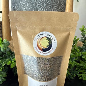 May include: A brown paper bag of dried lavender, labeled "Nature's Remedy Apothecary." The bag has a clear window showing the lavender and a label that reads "Lavender Lavandula x Intermedia 5oz."