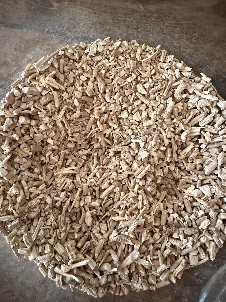 May include: A close-up shot of a pile of small, light brown, irregularly shaped pieces. The pieces appear to be dried, possibly wood or plant material, and are scattered across the surface.