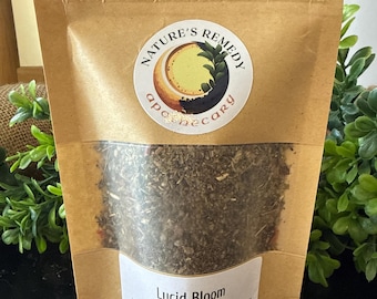 May include: A brown paper bag with a clear window displaying a herbal tea blend. The bag features a circular label with the text "Nature's Remedy Apothecary". The text "Lucid Bloom" is visible on the label, along with the weight of the tea, which is .5oz.