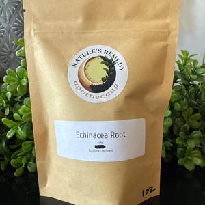May include: A brown paper bag labeled "Nature's Remedy apothecary" with a circular sticker. The bag contains "Echinacea Root" and "Echinacea Purpurea". The bag is 1 oz.