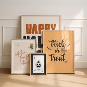 Puede incluir: Cuatro l&aacute;minas de pared enmarcadas con motivos de Halloween. Un cartel grande dice HAPPY HALLOWEEN en naranja y negro. Un cartel vertical dice trick or treat con una telara&ntilde;a. Una l&aacute;mina estilo postal dice with love from the other side. Una tarjeta peque&ntilde;a muestra un as de calabazas.