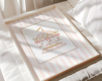 May include: A framed print featuring a carousel illustration. The artwork has a pink and white striped background with a scalloped border. The carousel is depicted in soft pinks and gold, with decorative bows and horses. The frame is white with a gold edge.