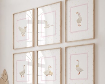 May include: Set of six framed prints featuring watercolor illustrations of geese with pink polka dot backgrounds. The geese are depicted in various poses, including flying, standing, and sitting. The frames are a light wood color.