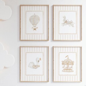 May include: Four framed prints with a nursery theme. Each print features a different illustration: a hot air balloon, a carousel, a swan, and a rabbit. The prints have a beige and white striped background and are framed in light wood.