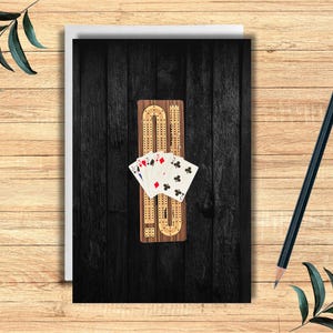 May include: A wooden cribbage board with a black background and playing cards. The cribbage board has a dark wood finish and is made of high-quality wood. The playing cards are standard playing cards with a red and black design.