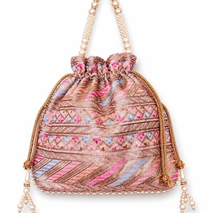 May include: A pink and brown embroidered drawstring bag with a pearl beaded handle and tassel accents. The bag features a detailed pattern with pink, blue, and gold threads, and is embellished with sequins. The handle is made of white pearls.