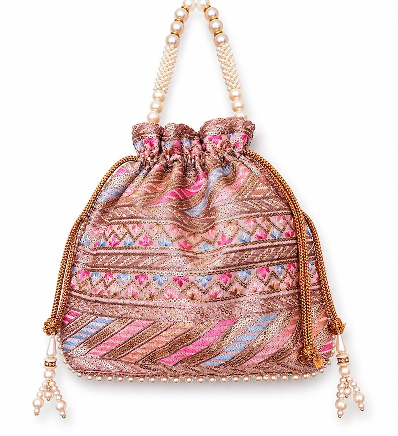 May include: A pink and brown embroidered drawstring bag with a pearl beaded handle and tassel accents. The bag features a detailed pattern with pink, blue, and gold threads, and is embellished with sequins. The handle is made of white pearls.