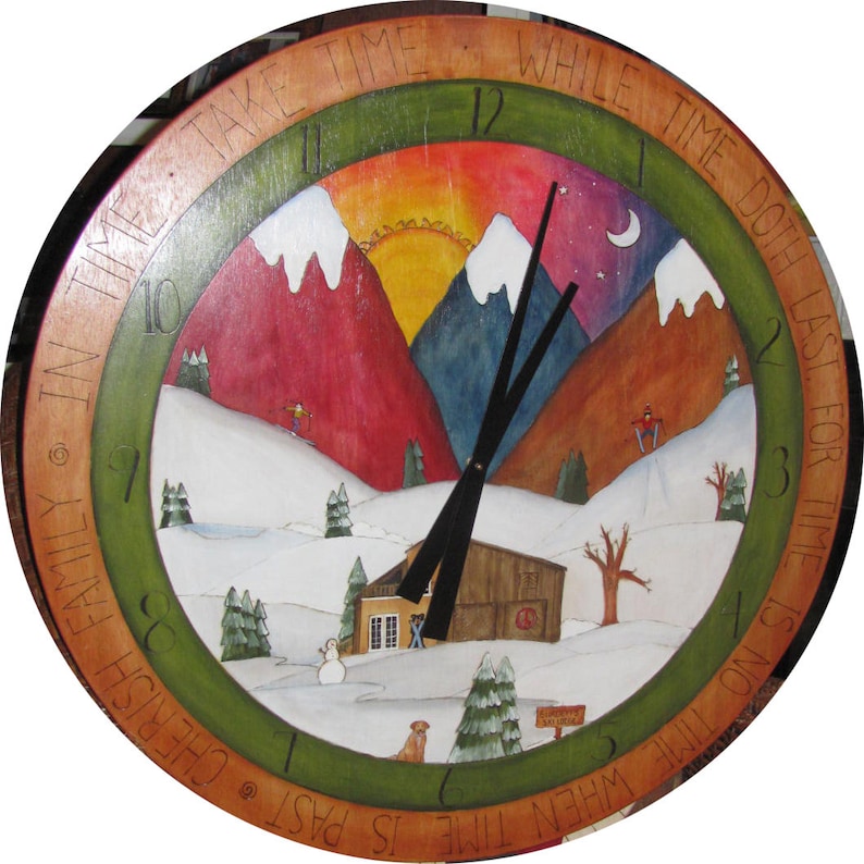 May include: A wooden clock with a painted scene of a snowy mountain landscape. The clock face features Roman numerals and the text "Take time while time doth last. For time is no time when time is past. Cherish family in time."