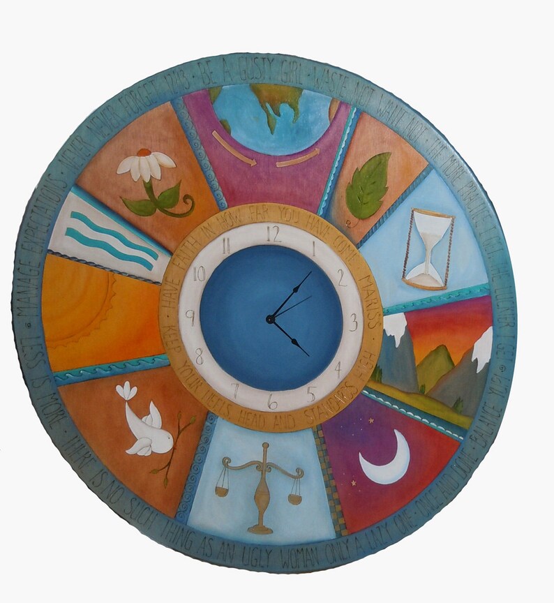 May include: A round wooden clock with a blue face and white numbers. The clock is decorated with colorful painted images and text around the edge. The text reads "Manage Expectations - Be a Gushy Girl & Waste Not Want Not The More Practice I Get The Slicker I Get - Have Faith In What You Have Come To - Keep Your Heels, Head and Standards Light - Less Is More There Is No Such Thing As An Ugly Woman Only A Lazy"