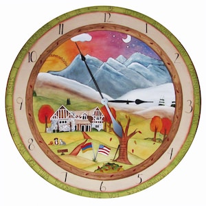 May include: A round wooden clock with a painted scene of a house in a mountain landscape. The clock face has Roman numerals and the words "Be Joyful Always Pray Continually Give Thanks In All Circumstances" around the edge. The clock hands are pointing to 12:00.
