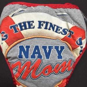 May include: Gray and red diaper with a life preserver graphic and the text "The Finest Navy Mom".