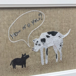 May include: Embroidered artwork featuring two dogs on a beige linen background. The larger dog is white with black spots and is saying "How are you?" in a speech bubble. The smaller dog is black and is looking at the larger dog.