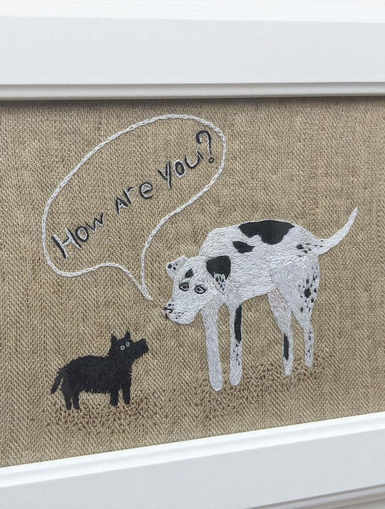 May include: Embroidered artwork featuring two dogs on a beige linen background. The larger dog is white with black spots and is saying "How are you?" in a speech bubble. The smaller dog is black and is looking at the larger dog.