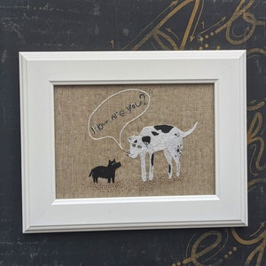 May include: A white framed embroidery with a black and white dog asking a black dog "How are you?" in a speech bubble.