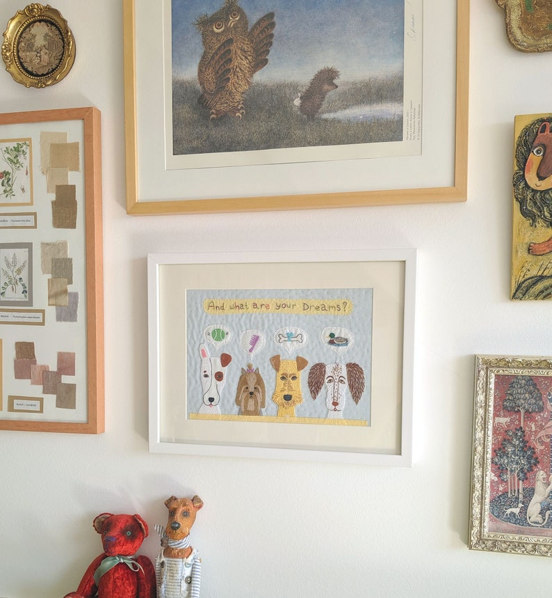 May include: A framed artwork with a white background and a blue sky. The artwork features five dogs with different colored fur and different expressions. Each dog has a thought bubble above their head with a different image in each bubble. The text "And what are your dreams?" is written at the top of the artwork.