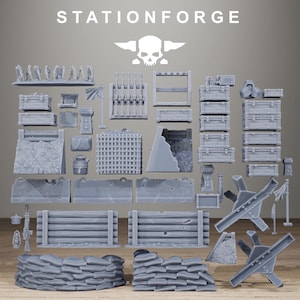 May include: A collection of grey miniature wargaming terrain pieces including sandbag walls, wooden barricades, crates, metal tank traps, and a flag. The text STATIONFORGE is printed at the top with a skull and anvil logo centered below it.