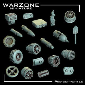 May include: A collection of miniature warzone components in various shapes and sizes, including cylinders, wheels, and a small shovel. The components are a muted gray color and are arranged against a black background. The text "WARZONE MINIATURE" is at the top.