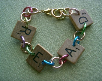 Scrabble Tile Bracelet READ with Multi Color Aluminum Rings Handpainted Flowers Hearts Upcycled Recycled Game Pieces Adjustable