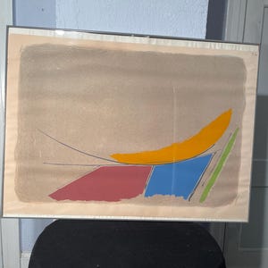 May include: Abstract art print with a yellow, blue, green, and red geometric design on a beige background.