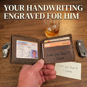May include: A brown leather bi-fold wallet featuring an ID window with an Arizona driver's license and a card slot engraved with the text Love you Dad - Claire. A small white card with the same handwritten message is placed next to the wallet.