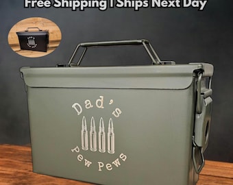 May include: An olive green steel ammo box with a black handle and latch. The box features the text "Dad's Pew Pews" with bullet illustrations. Additional text includes "Clean Engraving" and "Authentic Steel".