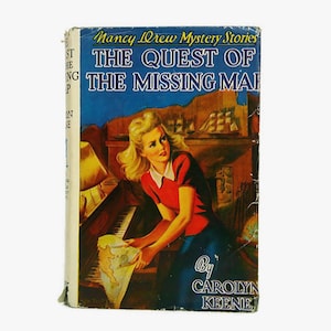 May include: Vintage hardcover book titled "The Quest of the Missing Map" from the Nancy Drew Mystery Stories series. The cover features an illustration of a woman in a red top and blue skirt holding a map, with a ship and landscape background.