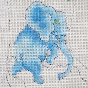 May include: A blue and white embroidered elephant with a green eye. The elephant is sitting on a white canvas.