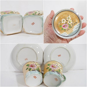 Pode incluir: Conjunto de duas ch&aacute;venas de ch&aacute; e pires japoneses vintage com desenhos florais. As ch&aacute;venas e os pires s&atilde;o brancos com detalhes dourados e apresentam um padr&atilde;o floral rosa e branco. A parte inferior das ch&aacute;venas e dos pires est&aacute; marcada com "Made in Japan".