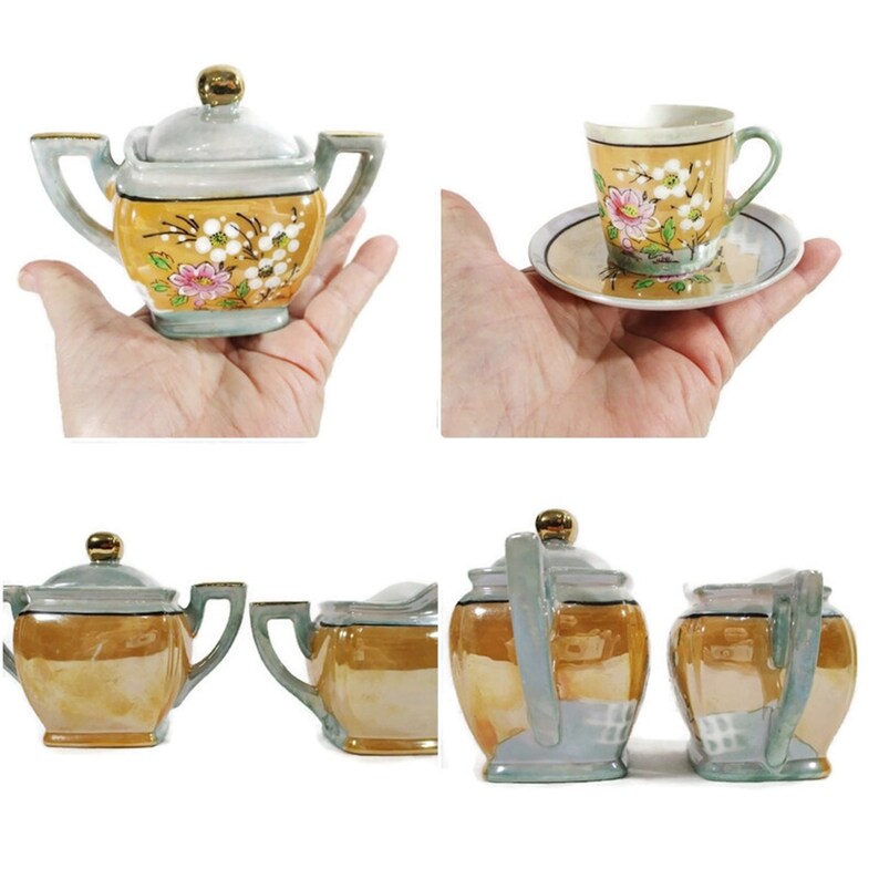 Pode incluir: Um conjunto de ch&aacute; vintage com um design floral amarelo e branco. O conjunto inclui um bule, um jarro de creme, um a&ccedil;ucareiro e uma x&iacute;cara de ch&aacute; e um pires.